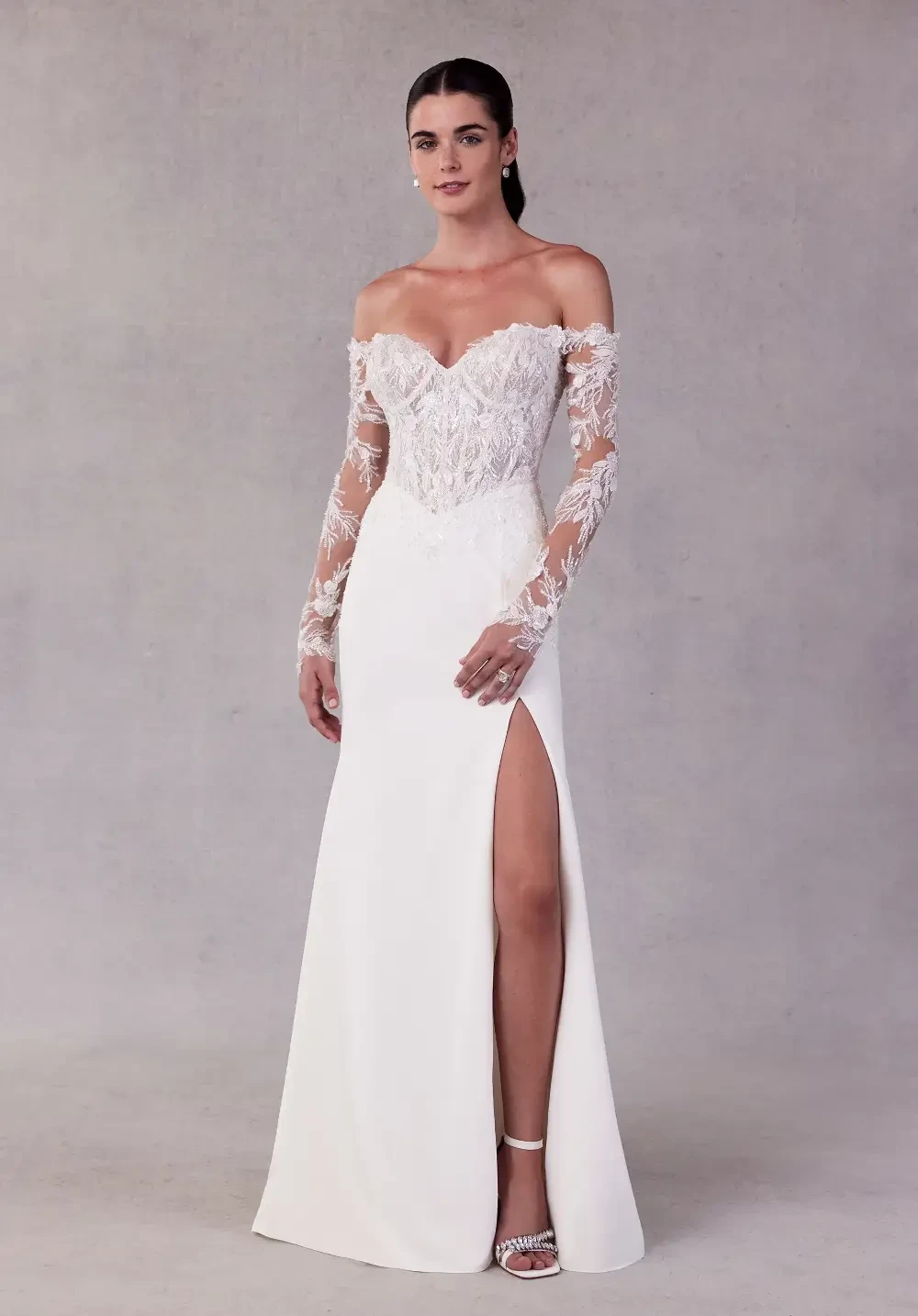 model is wearing an off the shoulder bridal gown