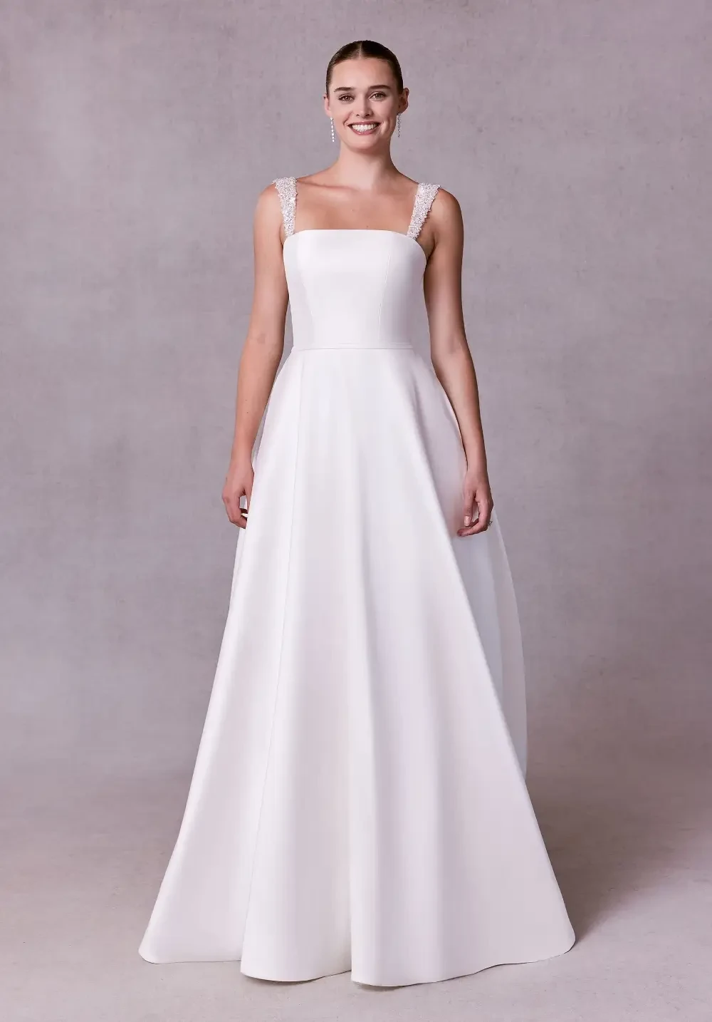 model is wearing a sleeveless a-line bridal gown