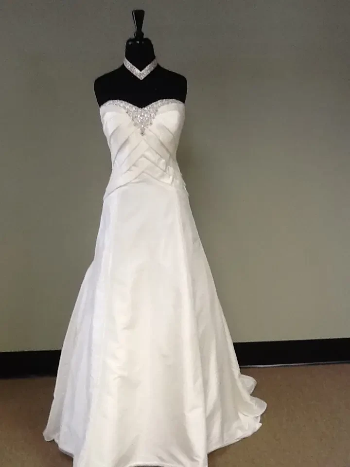 image shows a mannequin wearing a strapless bridal gown