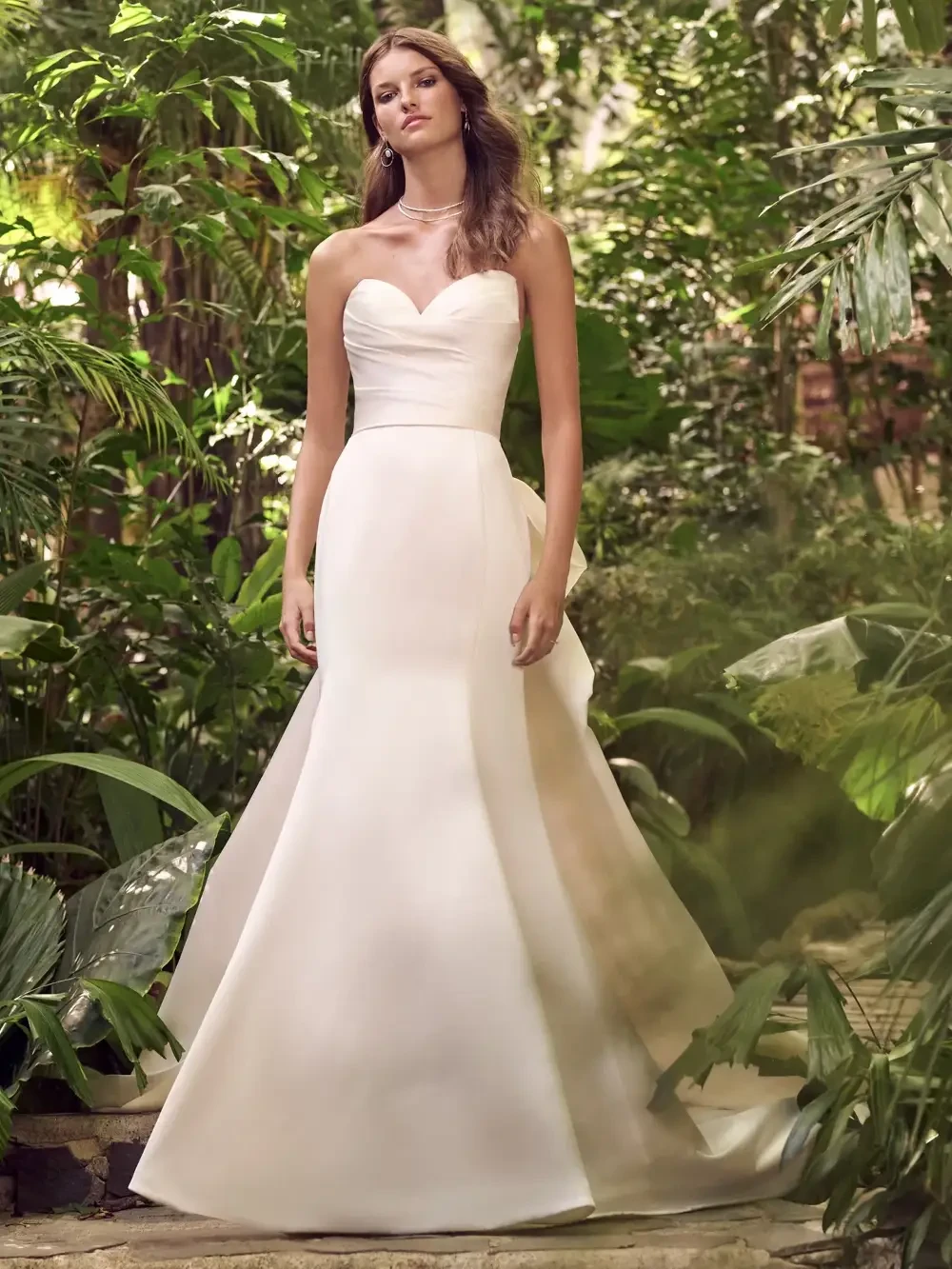 model is wearing a strapless mermaid wedding dress