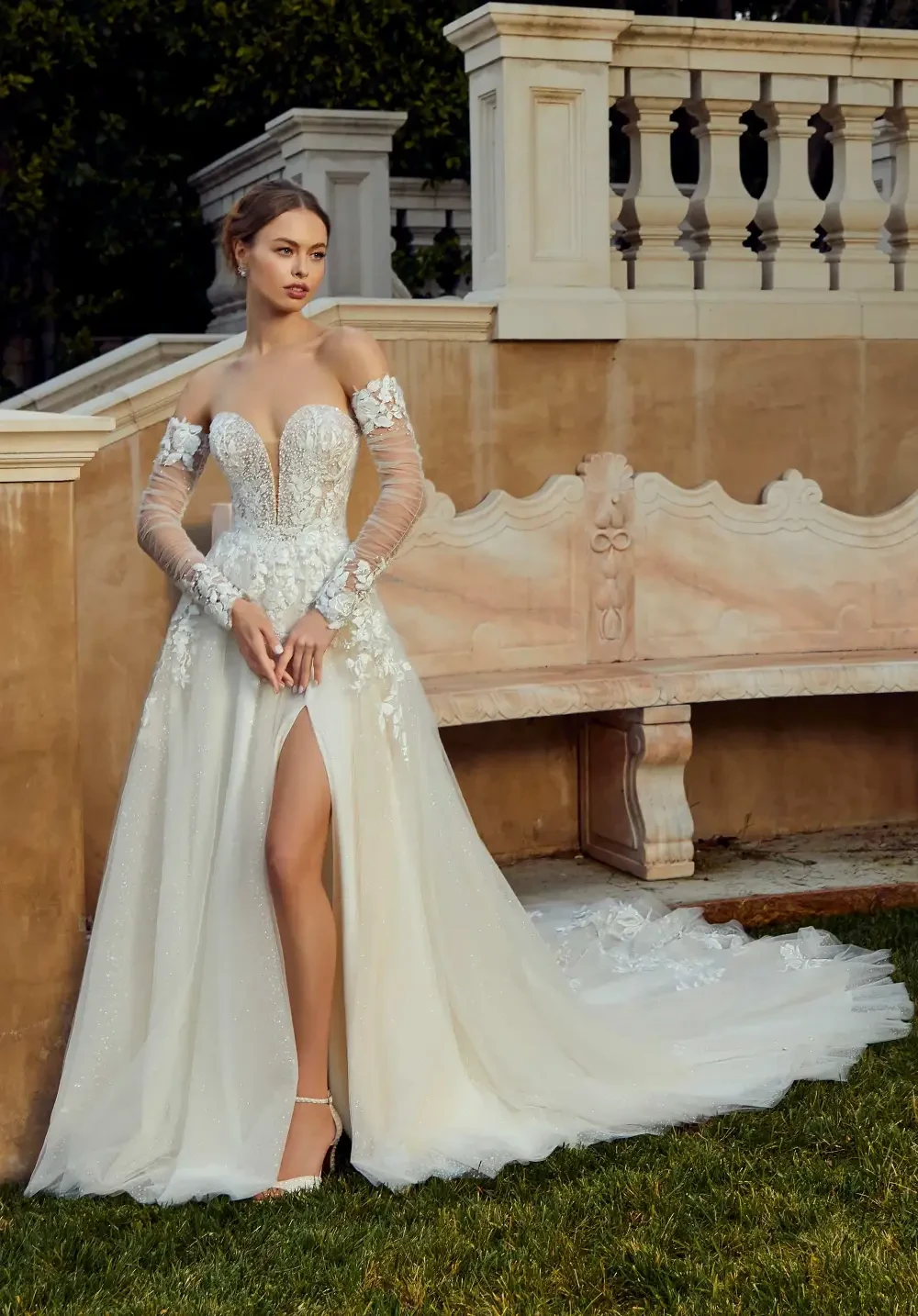model is wearing a long sleeve lace bridal gown